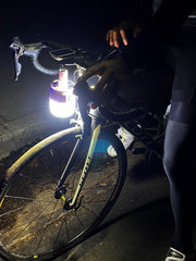 Gravity Trading solar lantern hanging on a hook outdoors.
