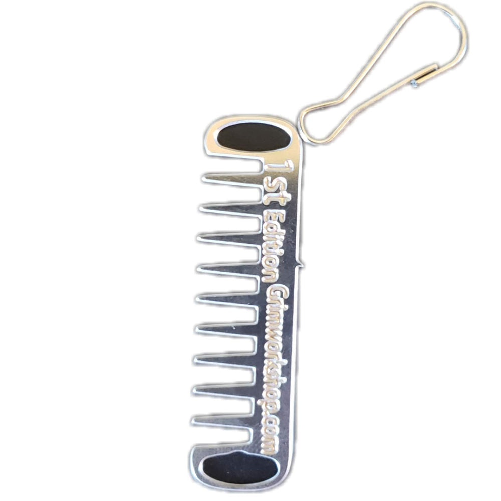 Grim Workshop Comb Micro Tool clipped to a zipper for quick grooming on the go.