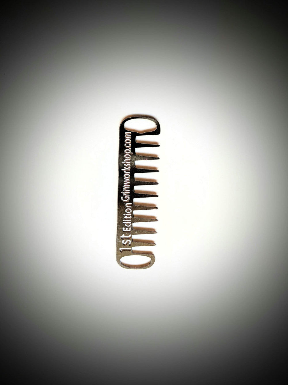 Grim Workshop Comb Micro Tool attached to a keychain for easy access anywhere.