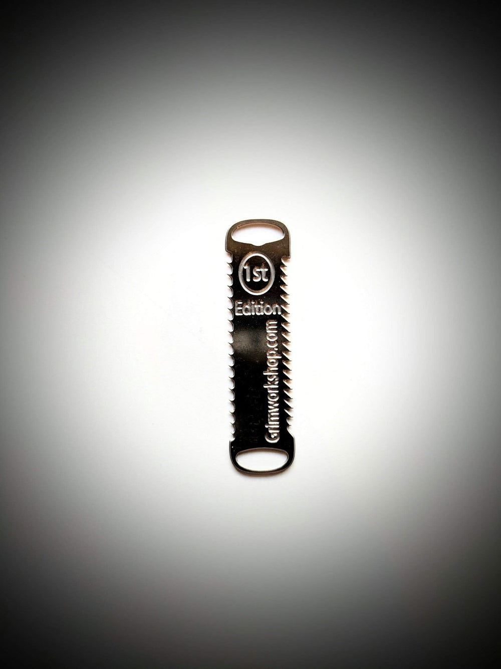 Grim Workshop compact tool with grip-friendly end holes for cords.