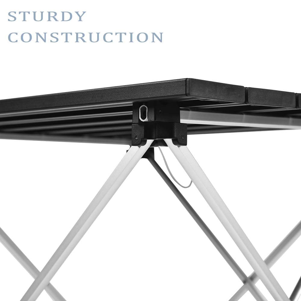 Grope camping table during quick setup with chair illustrates easy tool-free assembly.