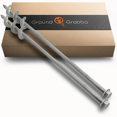 GroundGrabba screw-in tent stake in sandy ground for secure anchoring.
