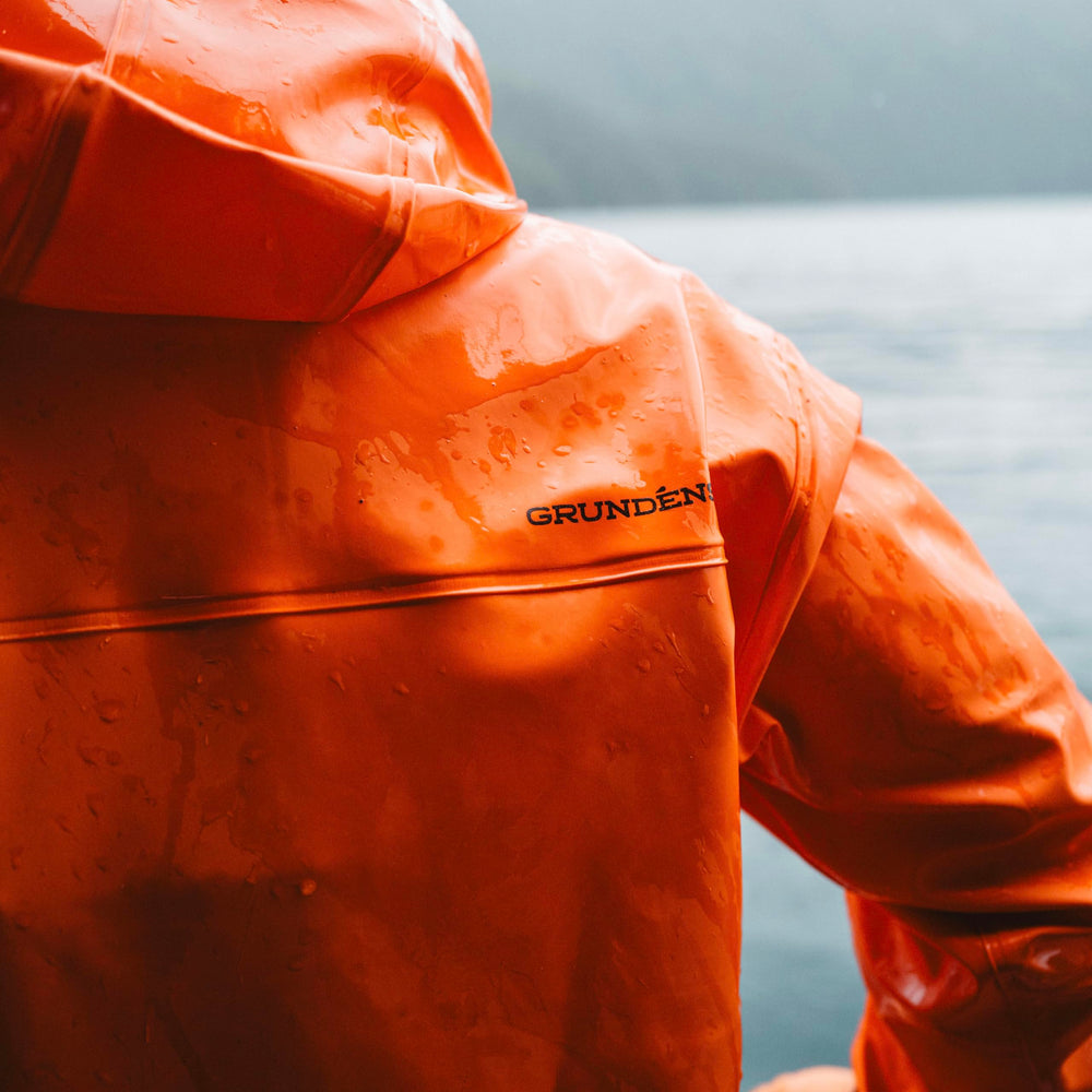 Grundéns Brigg 44 Parka orange pocket detail provides secure deck storage.
