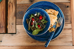 GSI Outdoors camp dinnerware set for four plates, bowls, and mugs ready for group meals.