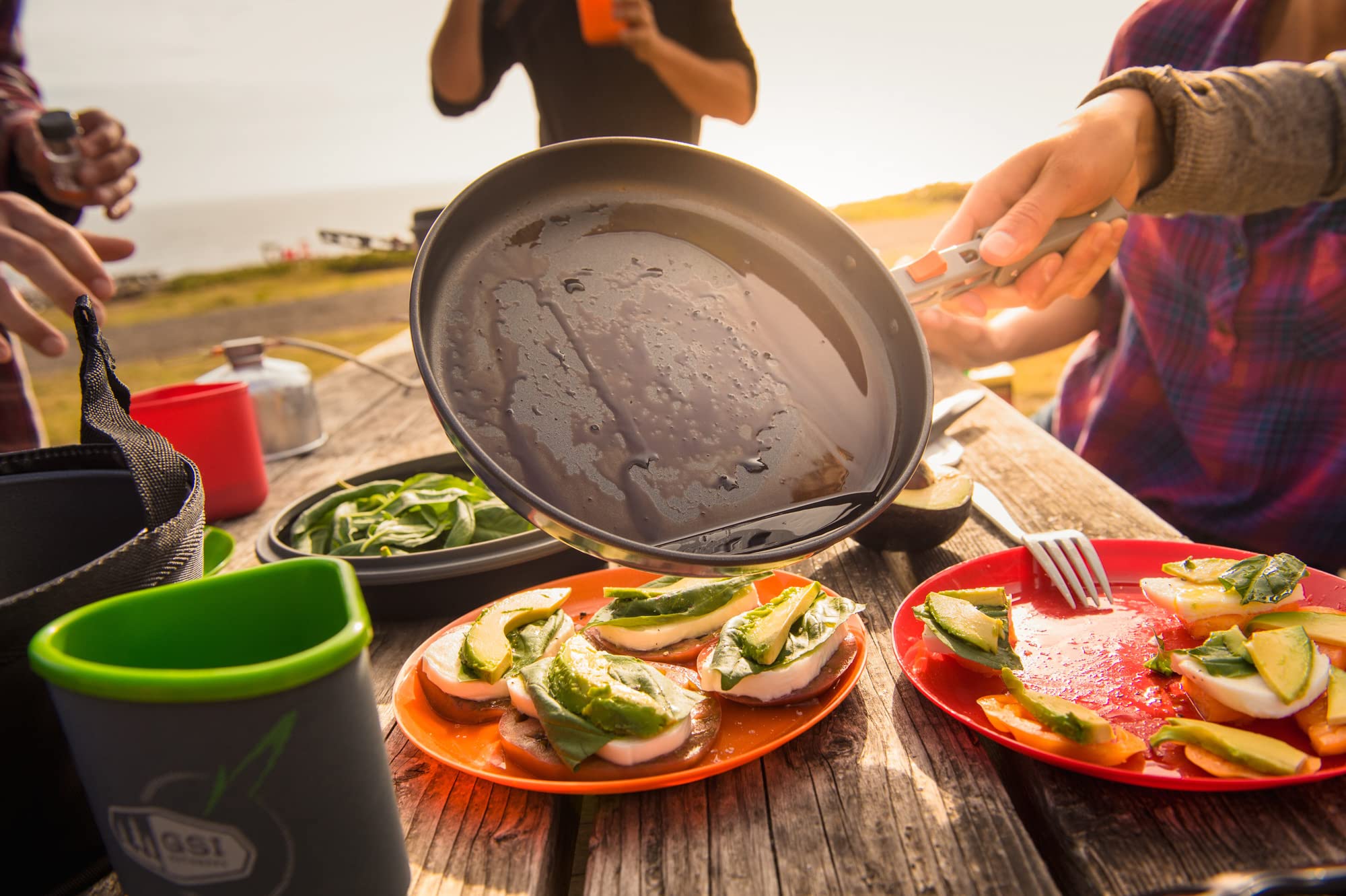 GSI Outdoors condiment containers pair with cutting board for portable flavor prep.