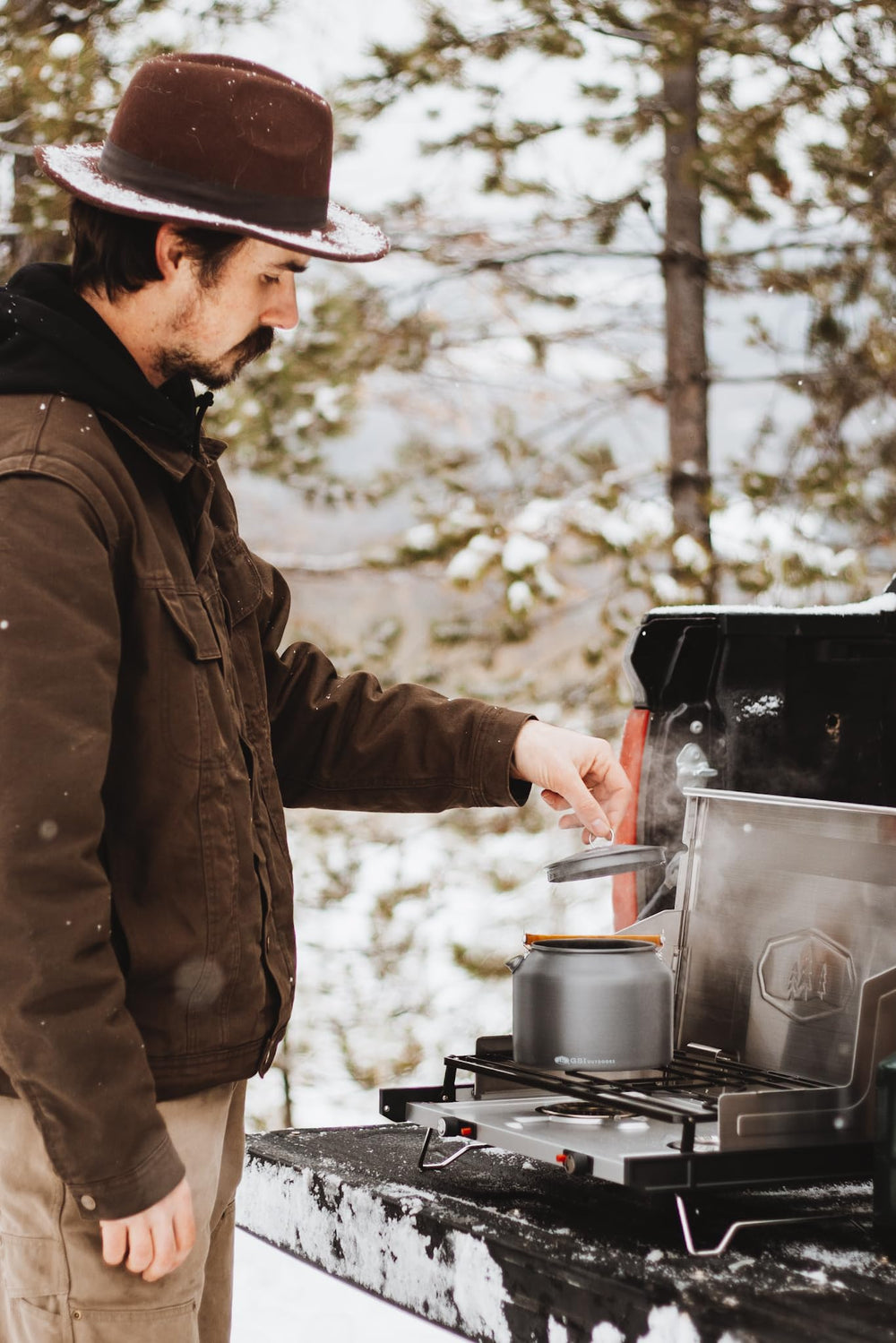 Kettle in camp kitchen setup for efficient outdoor cooking.