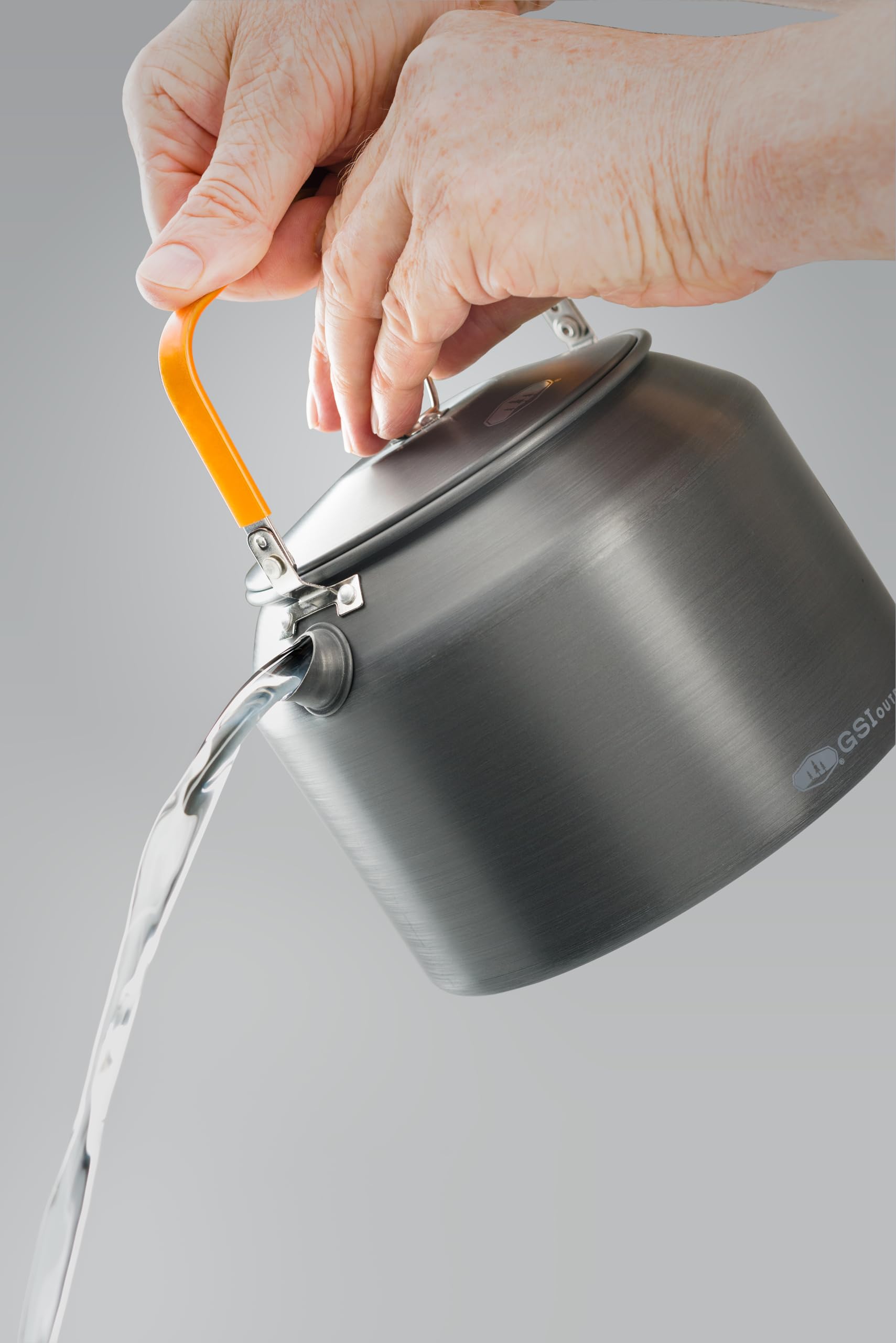 Halulite Tea Kettle on camp stove demonstrating compact ultralight design.