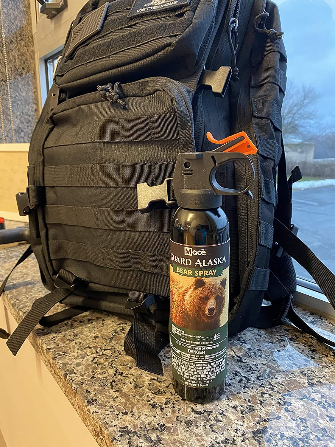 EPA-registered Guard Alaska bear spray visible on packaging.