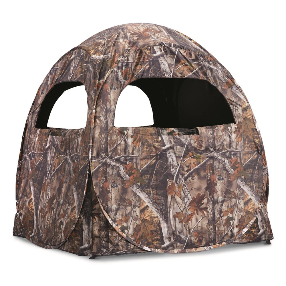 Guide Gear HuntRite Deluxe side view showing weather-resistant shell in natural terrain.