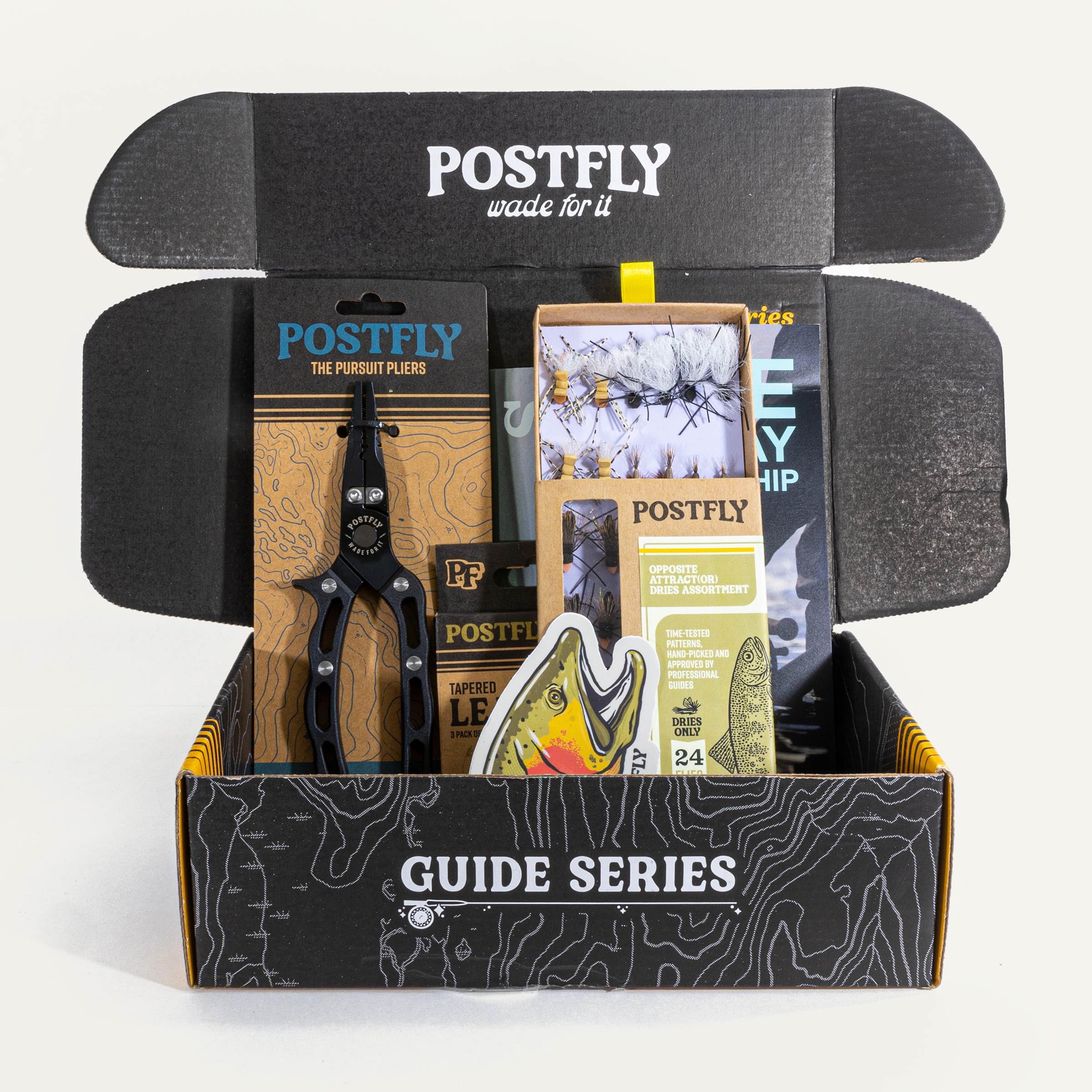 Box open showing 24 premium trout flies inside Guide Series kit