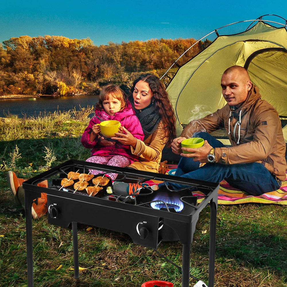 GYMAX camping stove in outdoor setting ideal for camping and tailgating.