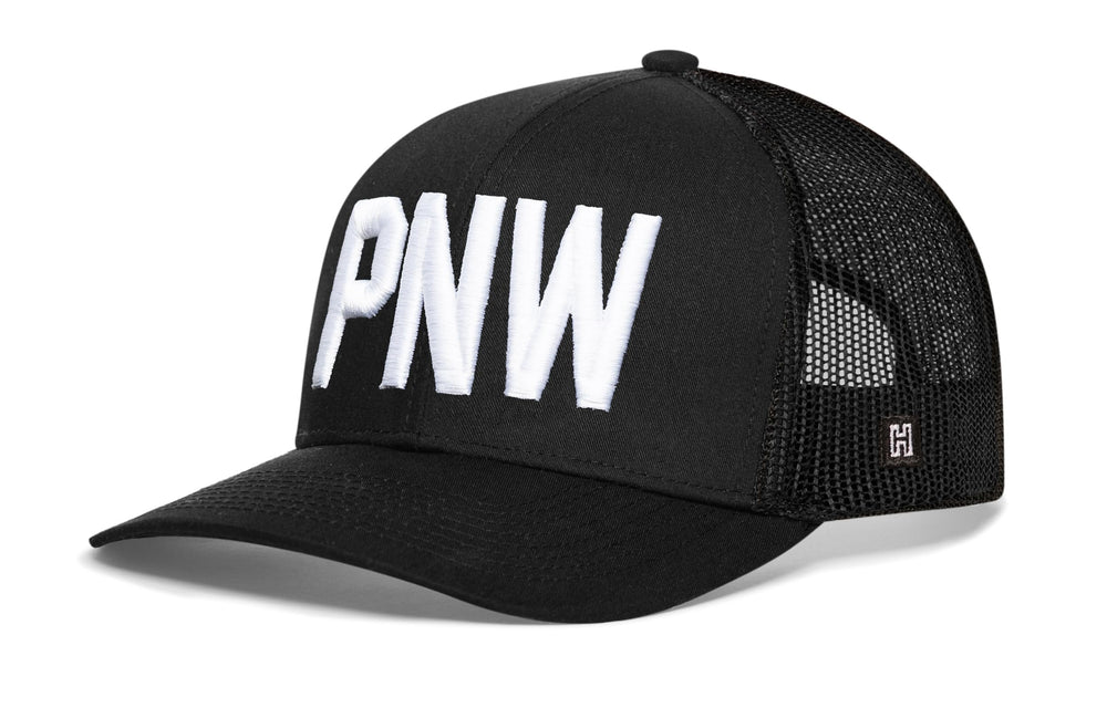 HAKA PNW Black Trucker Hat embroidery detail highlights premium block design.