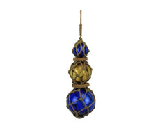 Blue and amber Japanese glass float with brown netting in nautical decor setting