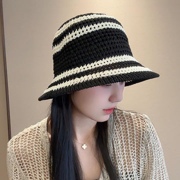 Foldable bucket hat folded for travel and packed in a tote