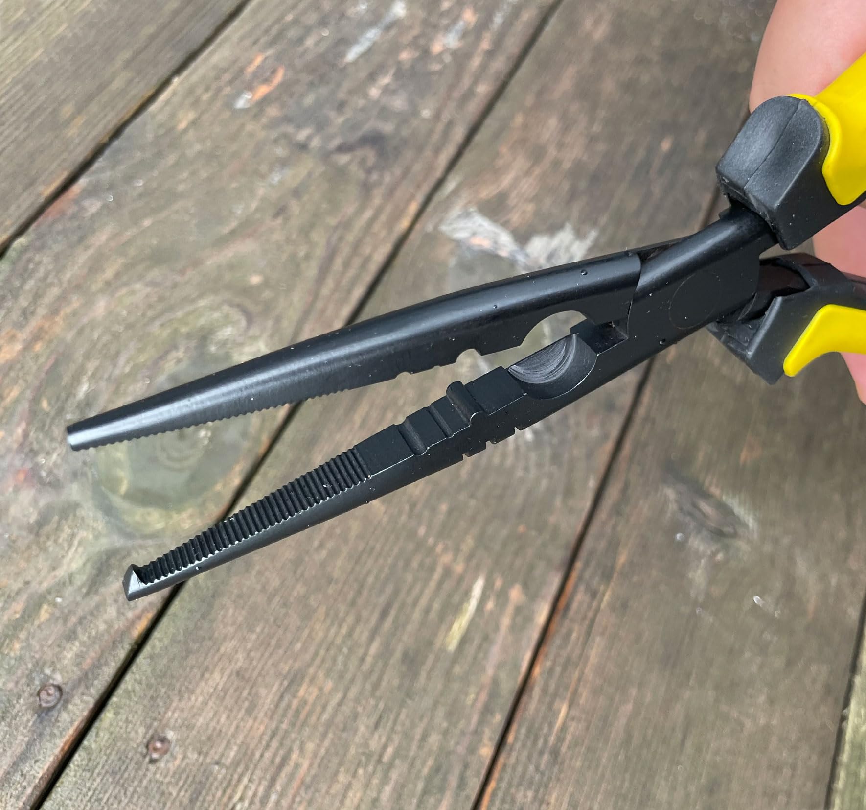 Pliers in use showing cinch holes and bait tuning slots