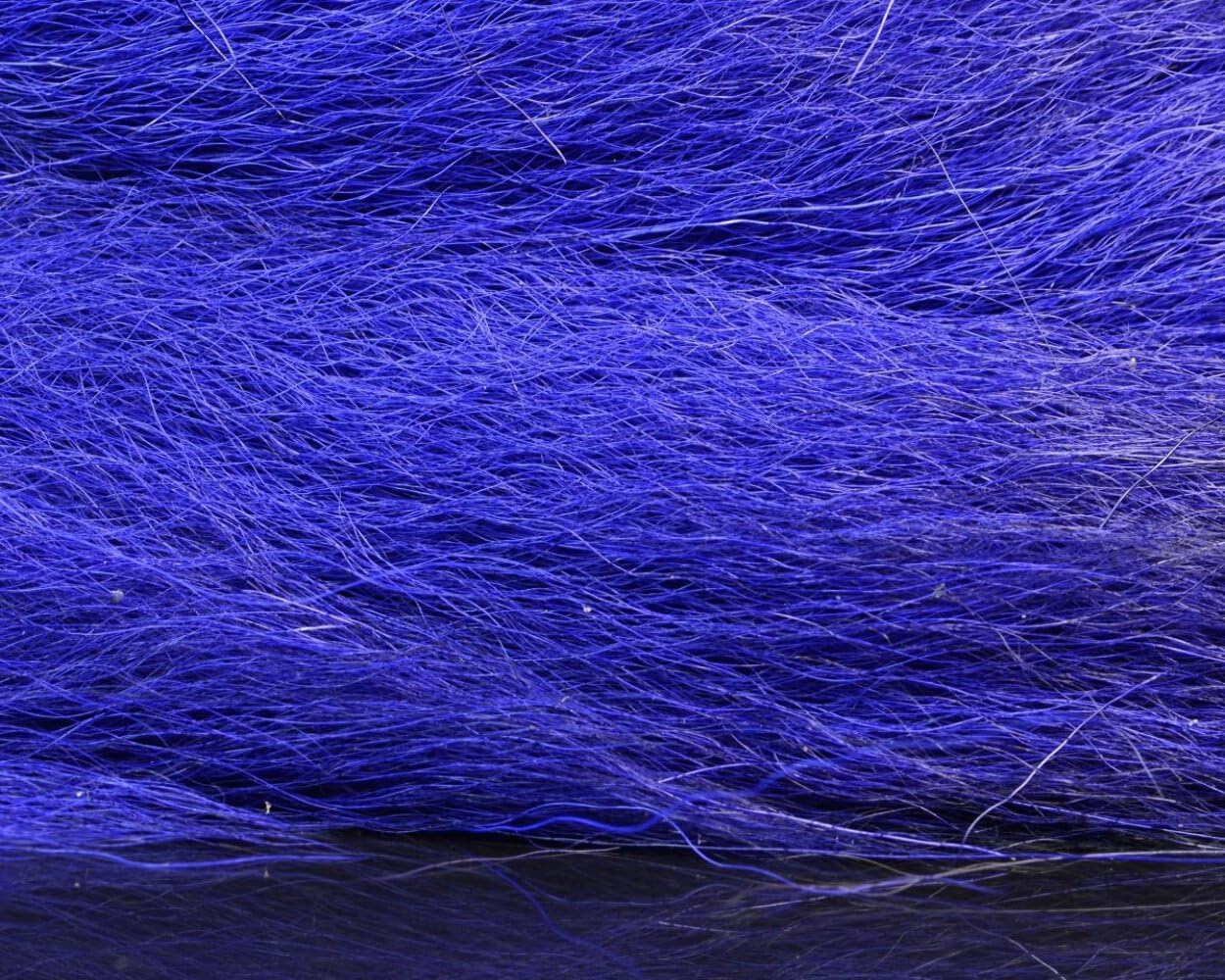 Hareline Dubbin HL Large Northern Bucktail in hand reveals tail length and texture.
