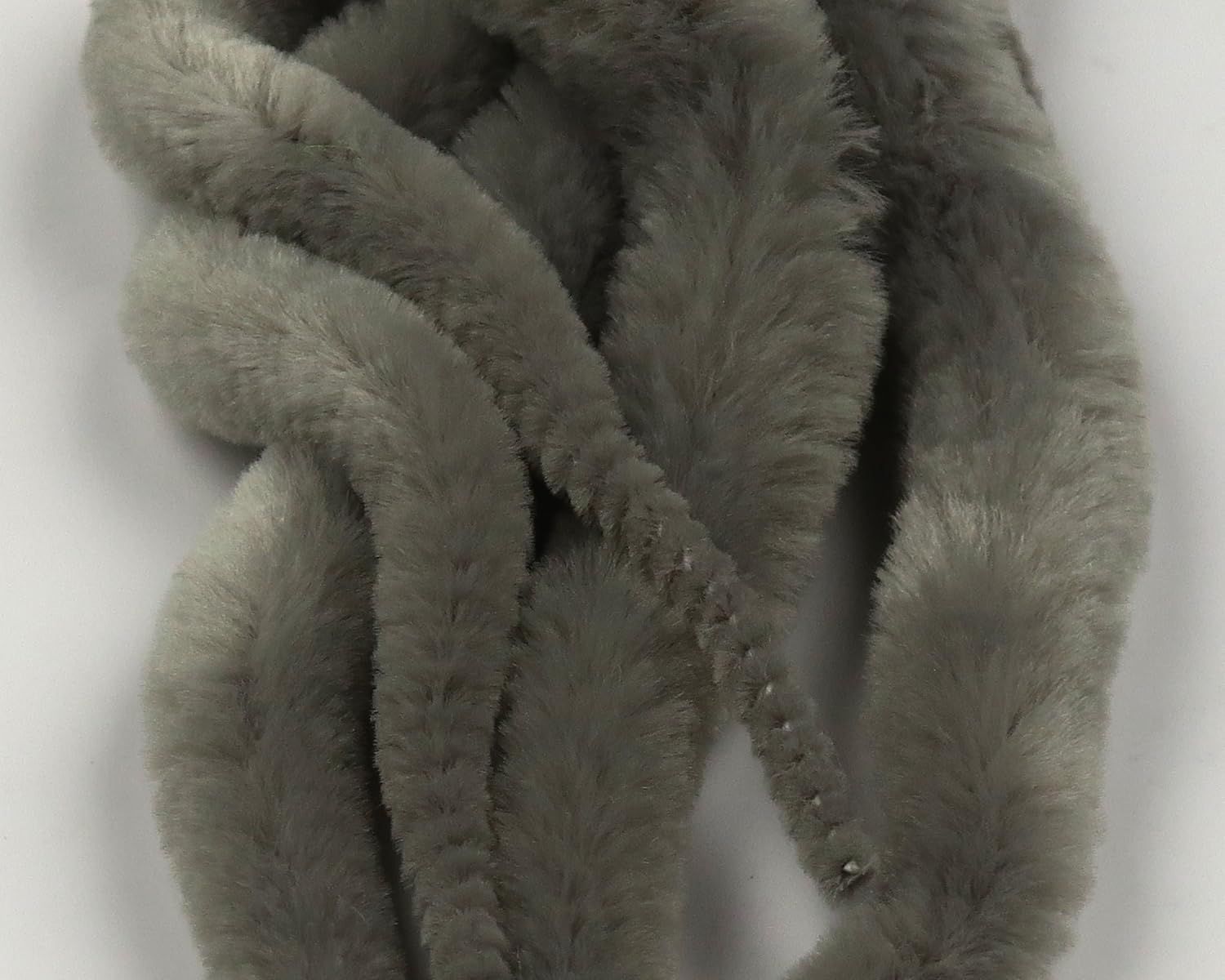 Hareline Dubbin Mangum's Mini Dragon Tail UV2 treated in gray; precise streamer action