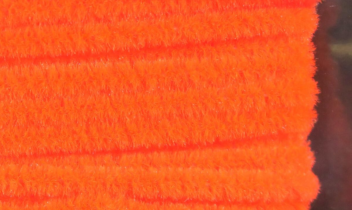 Hareline Dubbing Chenille in Florescent Orange adds bright texture to small fly patterns.