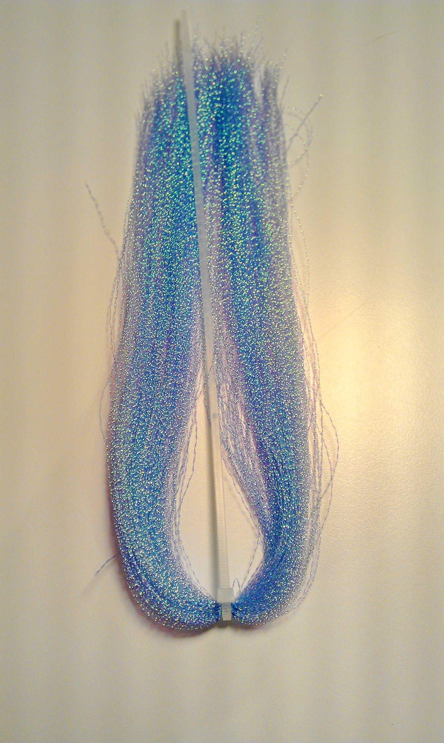 Hareline Krystal Flash Smolt Blue bottle shows vibrant color for flies.