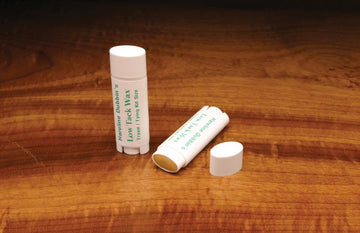 Hareline Low Tack Dubbing Wax oval tube helps control thread during fly tying.
