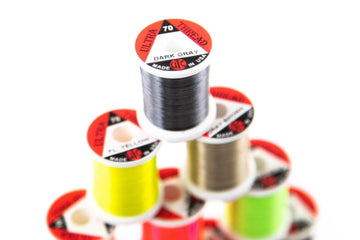 Spool shows 100 yards per reel, ready for extended tying sessions.