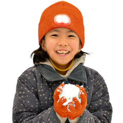 HEAD LIGHTZ kids beanie with built-in orange light for hands-free visibility during dusk play.