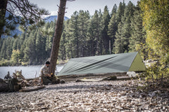 Helikon-Tex Supertarp Taiga Green attached to backpack demonstrates quick transport.