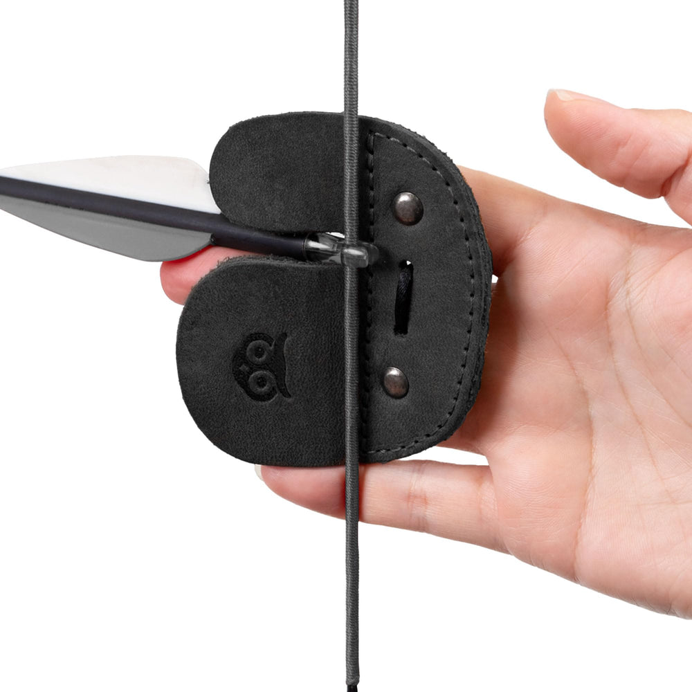 Hide & Drink archery finger tab worn on range highlighting protective comfort