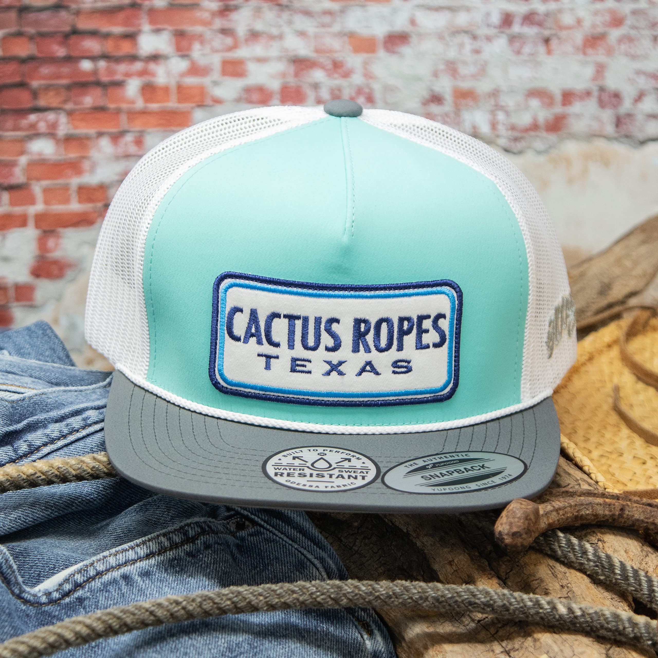 Side profile of HOOEY hat showing Cactus Ropes logo on mint/grey/white colorway