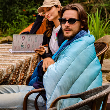 Hotkoko camping blanket multiple uses can become a shawl, rug, or sleeping bag.