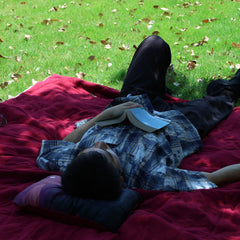 hotkoko packable blanket stores in a bag with straps for easy travel