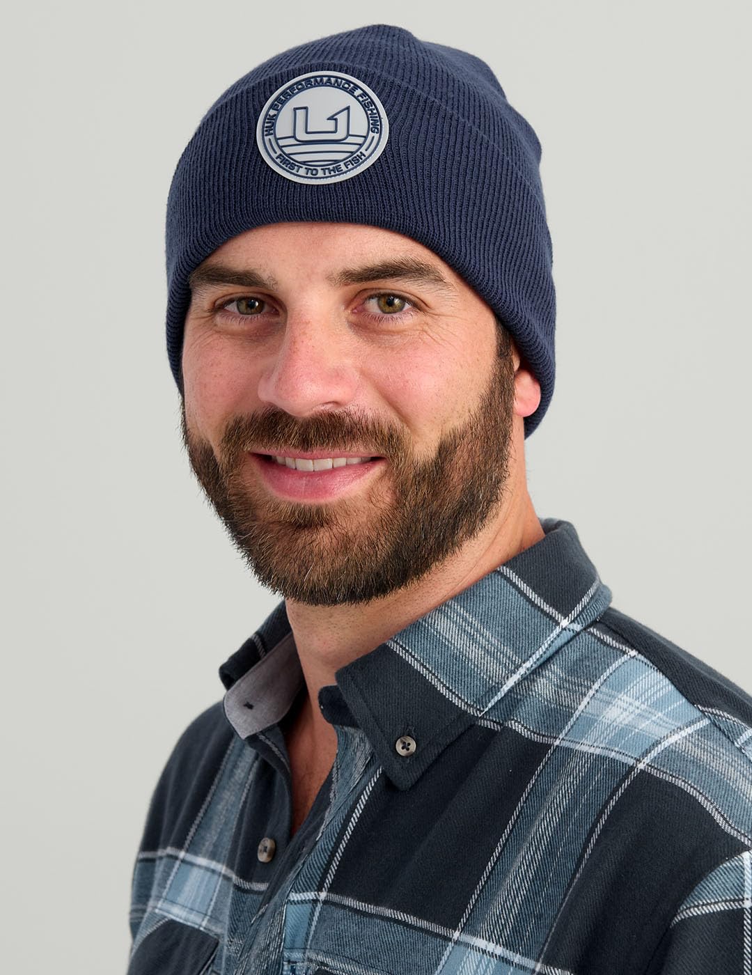 HUK embossed beanie with fishing gear setup signals practical warmth for anglers