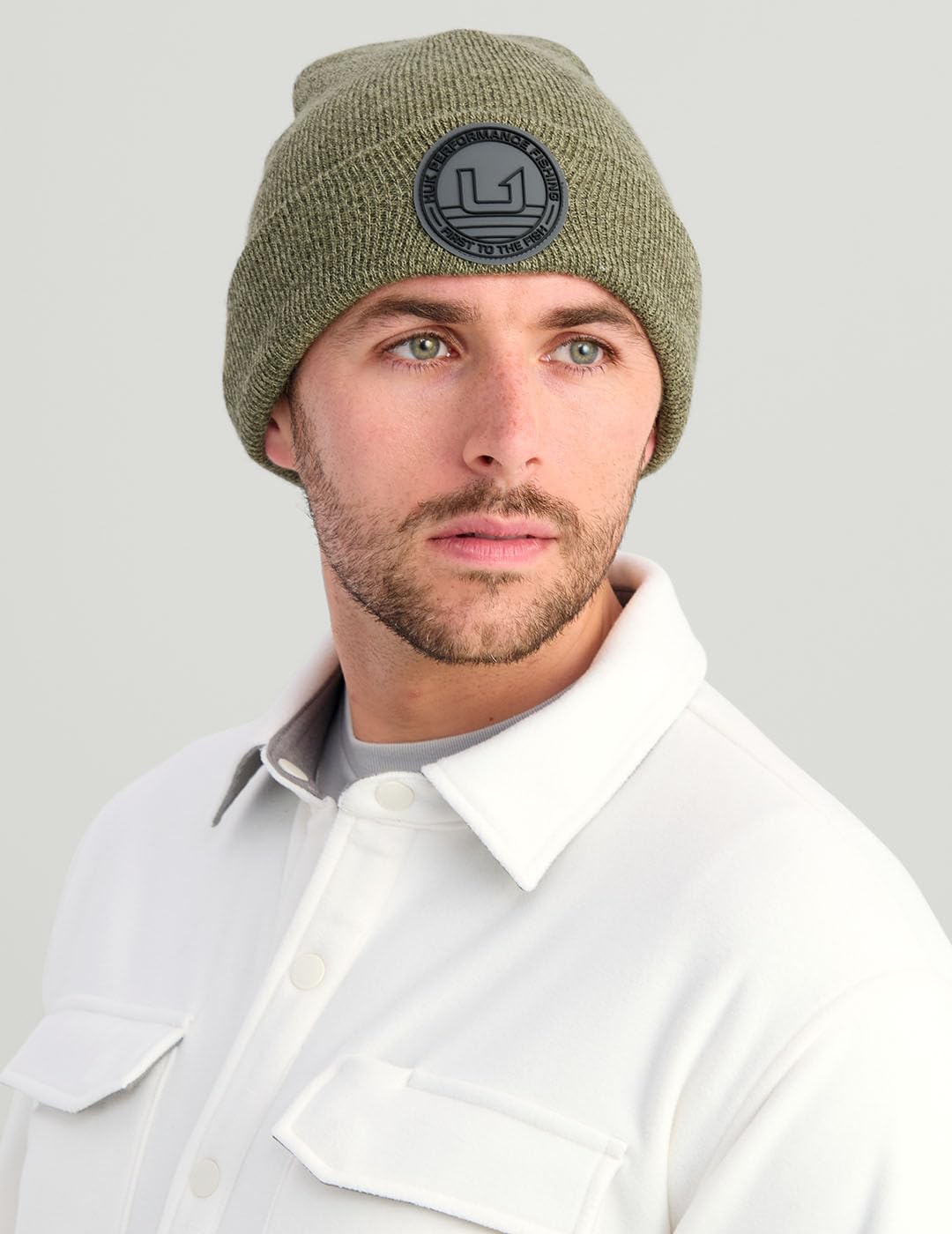 HUK embossed beanie outdoor styling on trail illustrates versatile warmth