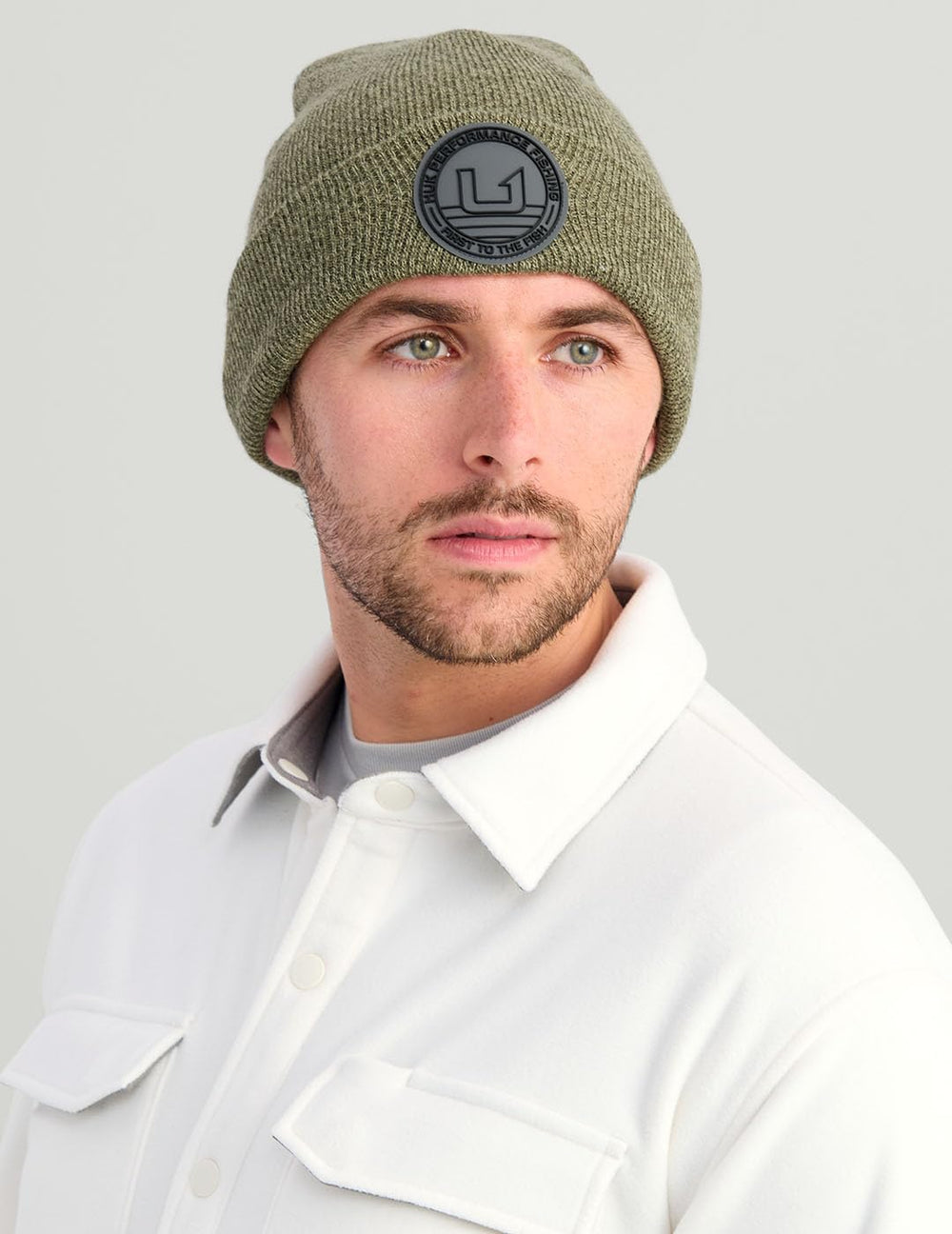 HUK embossed beanie outdoor styling on trail illustrates versatile warmth