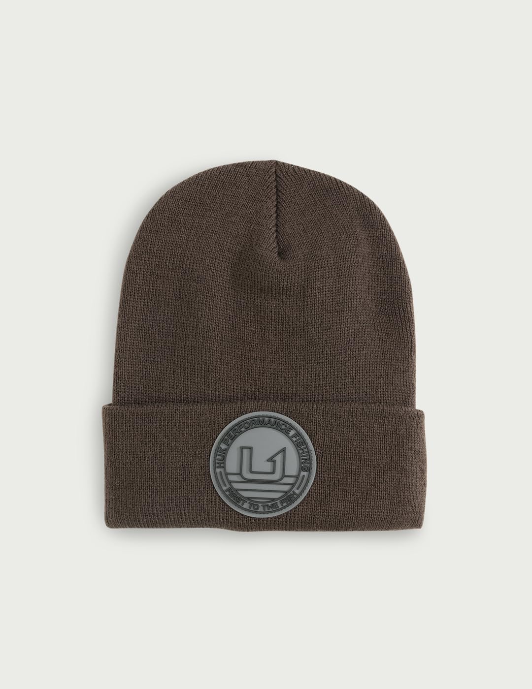 HUK embossed beanie street-style shot highlighting flexible fit for outdoor activities