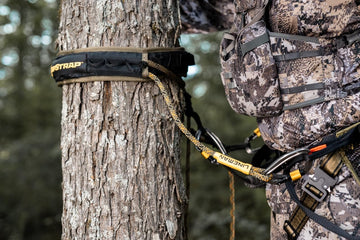 Hunter Safety System SlapStrap Double secures the lineman's belt for stable climbs.