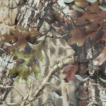 HYOUT camo netting being cut to size demonstrates easy customization.