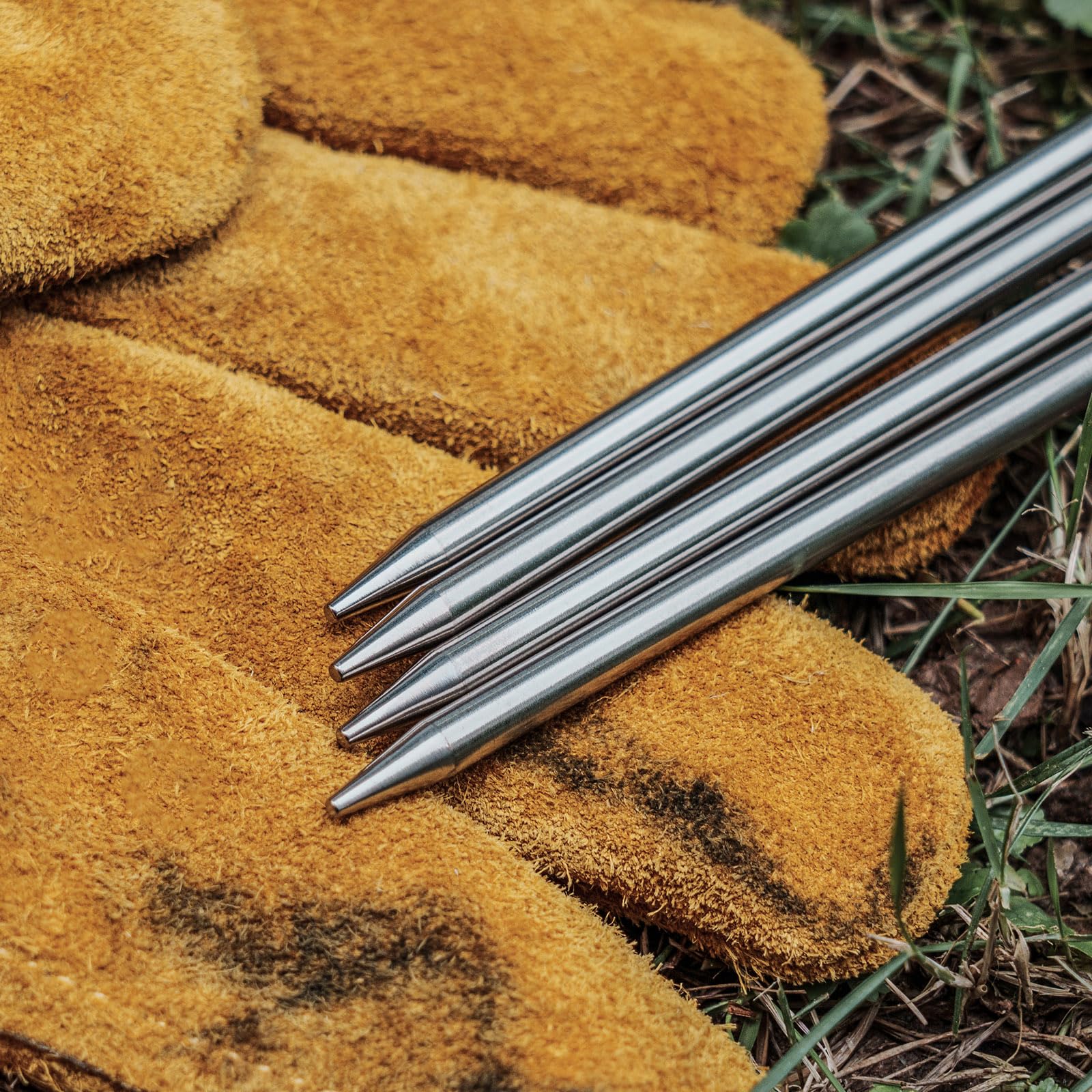 iBasingo tent stake in use to secure a shelter on varied terrain.