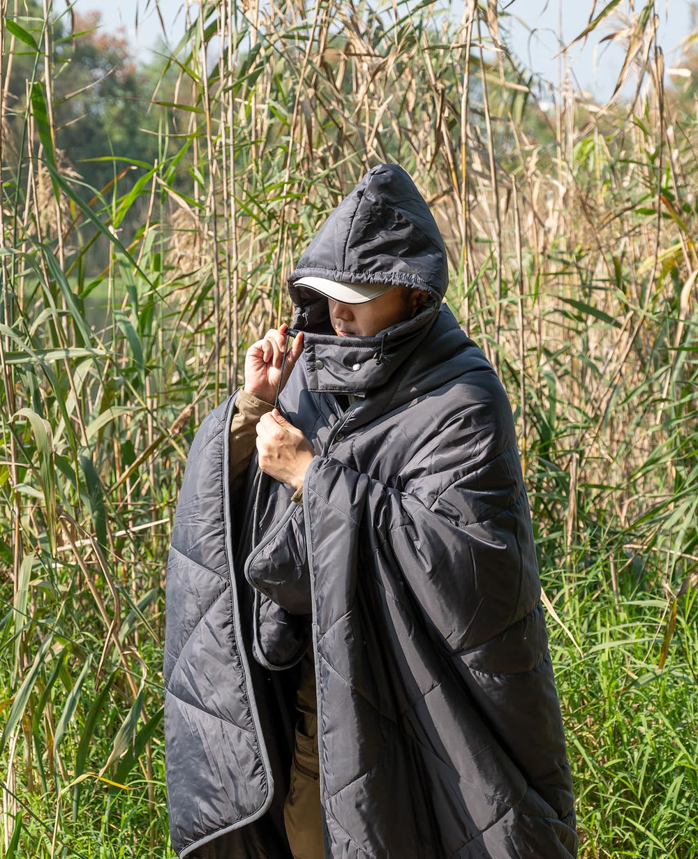 iClimb blanket worn as poncho demonstrates versatile outdoor comfort.