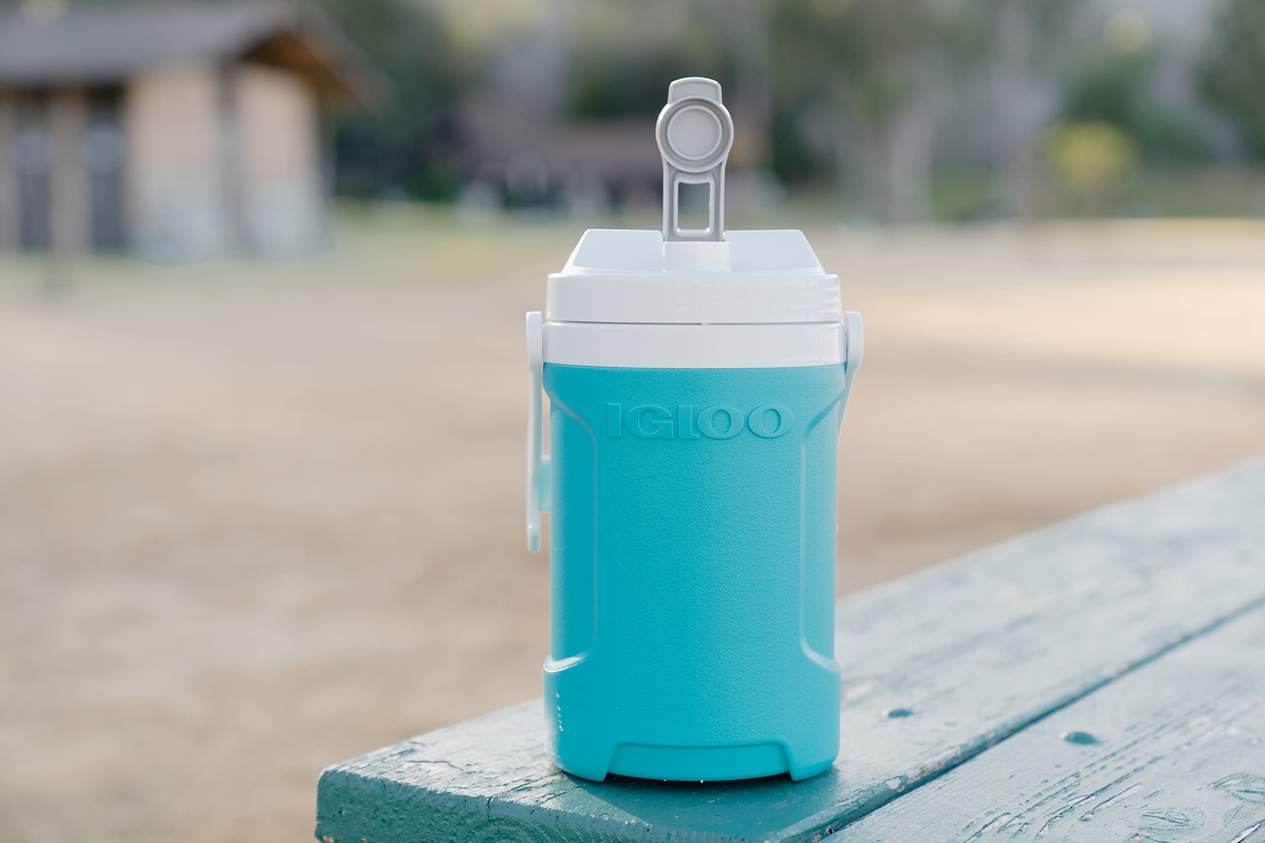 Igloo Aquamarine half-gallon jug with swing-up handle for spill-free carrying.