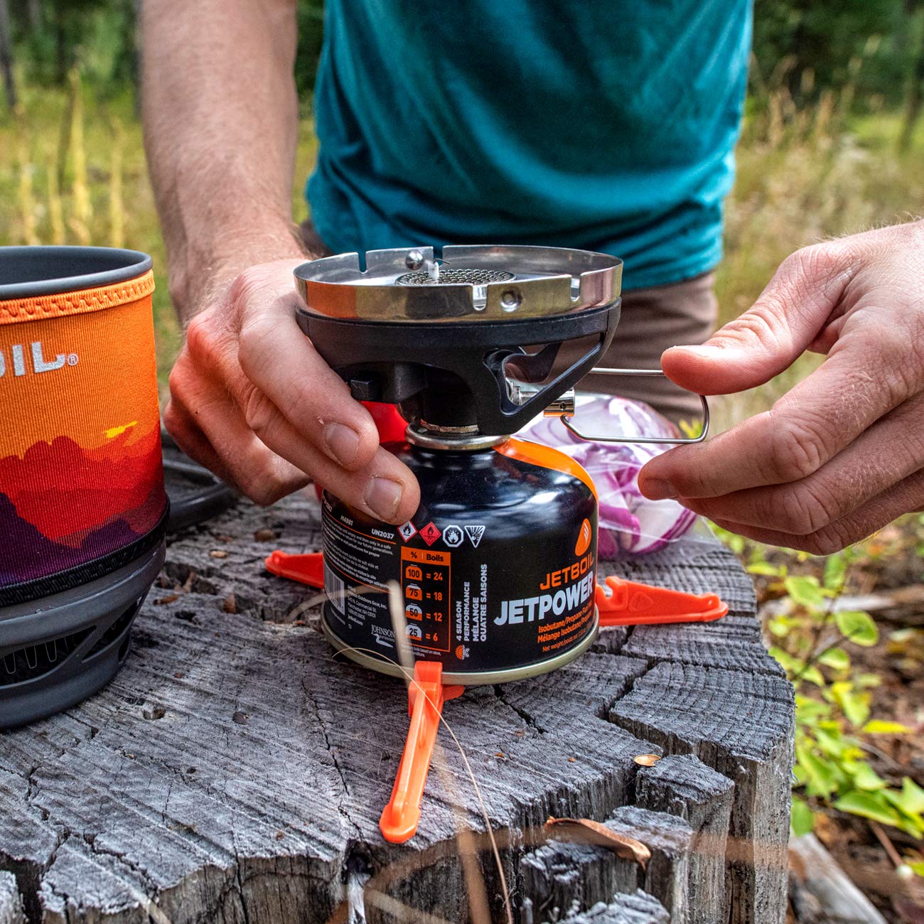 Jetboil MiniMo Sunset fuel-stabilizer in use for stable setup on uneven ground.