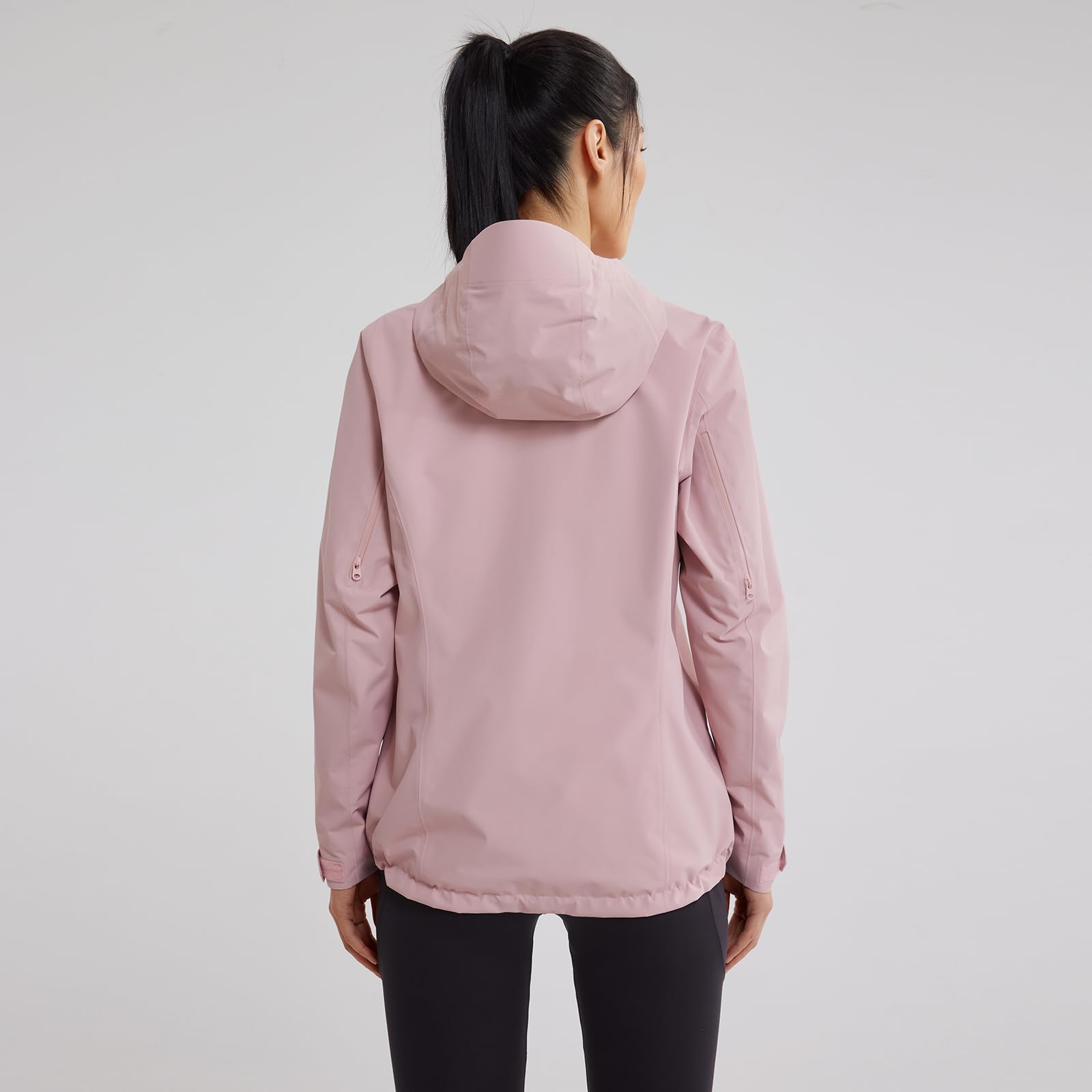 KAILAS women's raincoat on-trail hiking shows protection while exploring rugged terrain.
