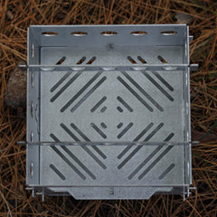 Kamp Ayisi folding camp stove showing compact storage and reliable heat in action.