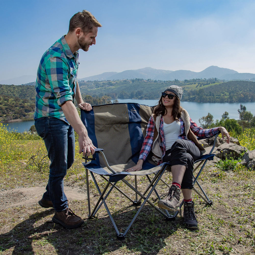 Kamp-Rite chair includes cup holders to keep drinks within reach.