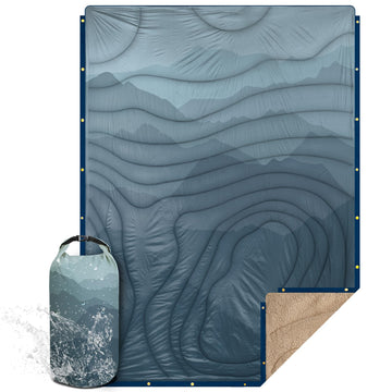 KawaGebo Kamp blanket with Sherpa lining opened for warm outdoor comfort on cold nights.
