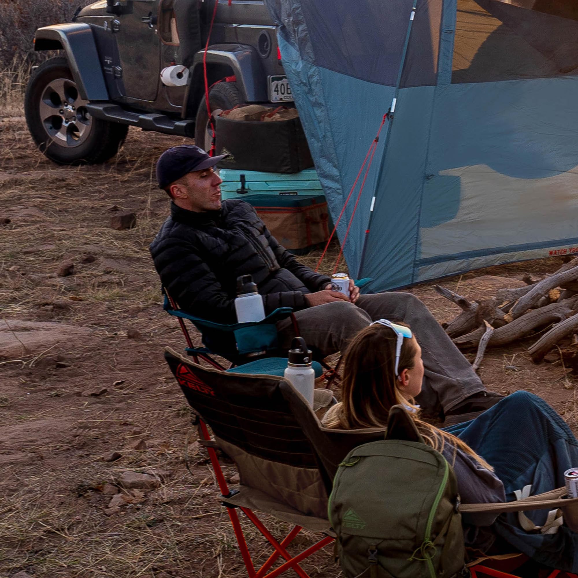 Kelty Deluxe Lounge Chair recline positions demonstrate customizable comfort by the campfire.
