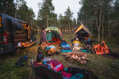 Kelty Galactic Down Blanket shown at campsite or on couch for versatile use.