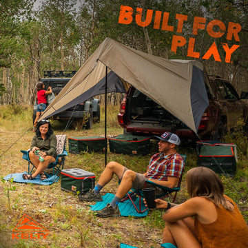 Kelty Waypoint Tarp campsite setup creates a sheltered space for gear and group.