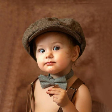Close up of a kids vintage tweed flat cabbie hat in coffee