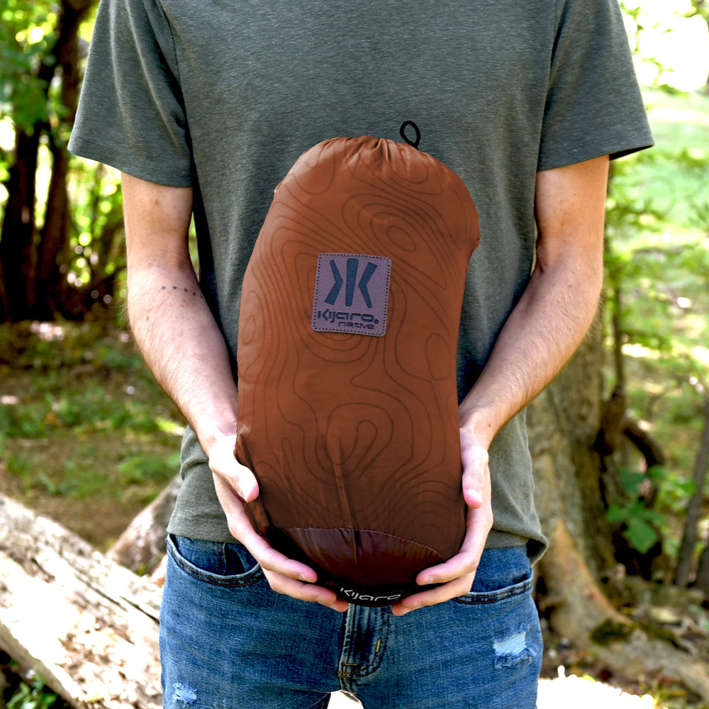 Kijaro Native Camp Quilt packed in a compact carry bag for easy portability